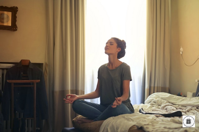 Woman meditating from home and relaxing